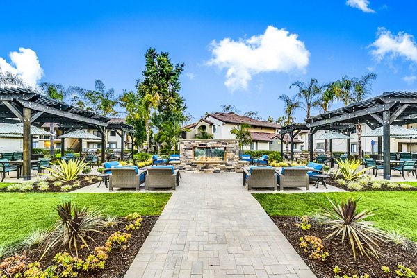 Altair Apartments: Cozy fire pit and grill area on a modern patio, perfect for social gatherings and relaxation in premium surroundings