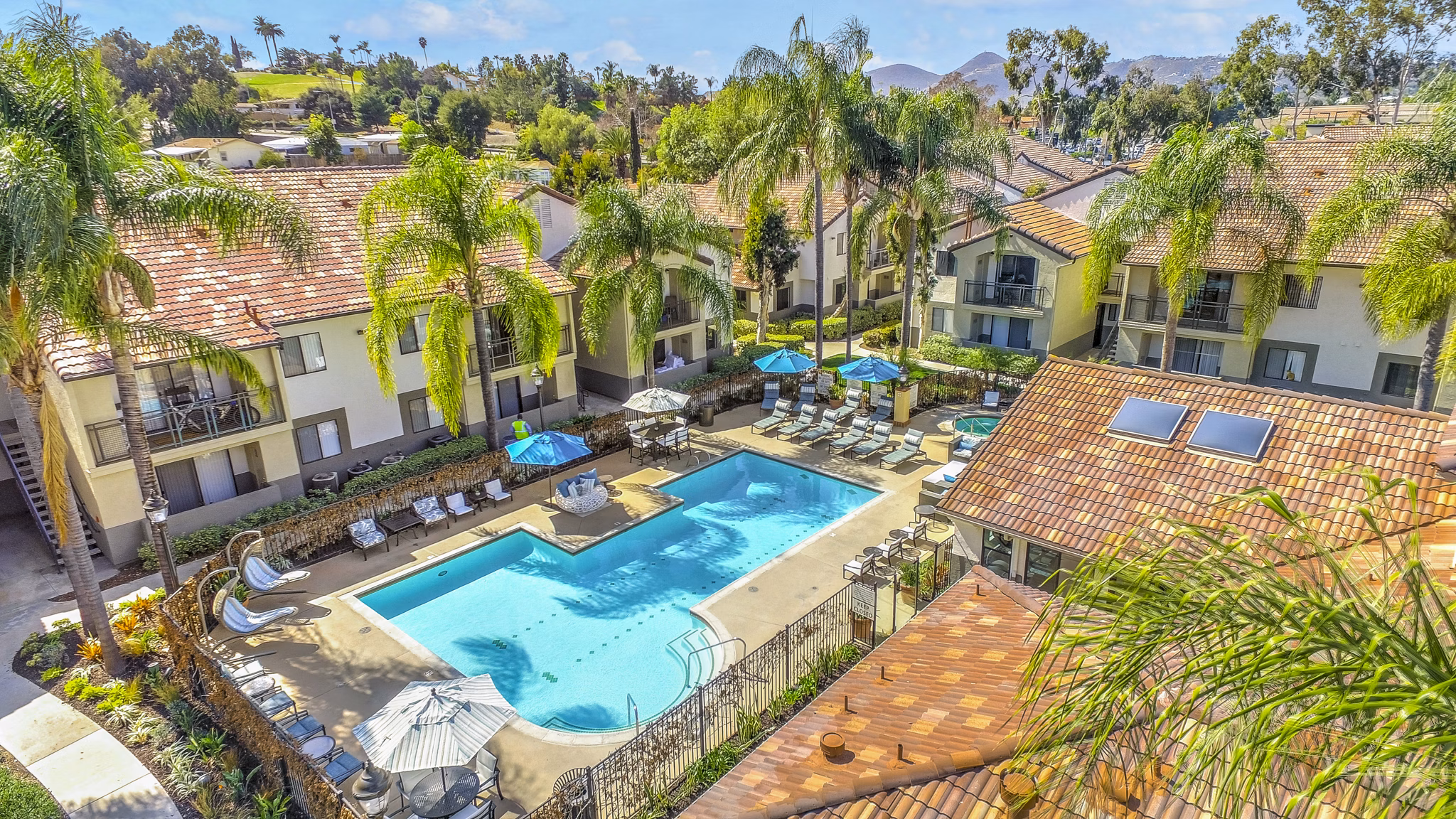 Olympic-size pool with sun loungers at Altair Apartments offering a luxury leisure experience