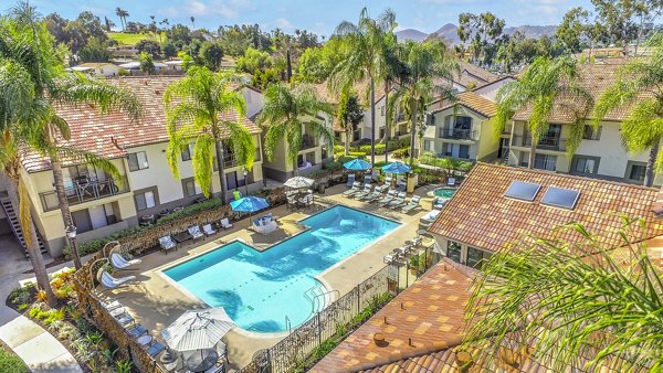 Olympic-size pool with sun loungers at Altair Apartments offering a luxury leisure experience