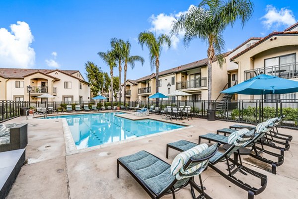 Stunning outdoor pool with modern loungers at Altair Apartments, perfect for relaxation and leisure activities in a luxury setting
