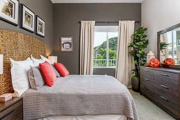 Cozy bedroom with modern decor at Altura Apartments, featuring stylish furnishings and ample natural light