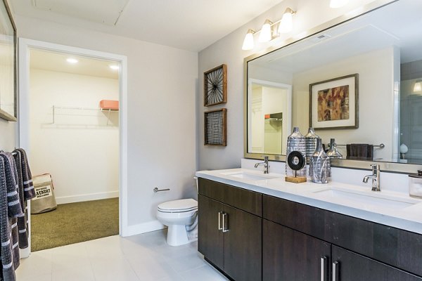 Altura Apartments: Modern bathroom featuring sleek fixtures and marble countertop
