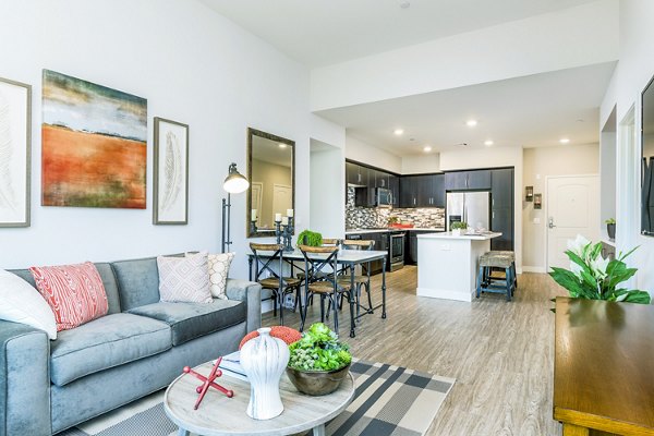 Spacious living room with modern furnishings at Altura Apartments in the luxury Greystar community