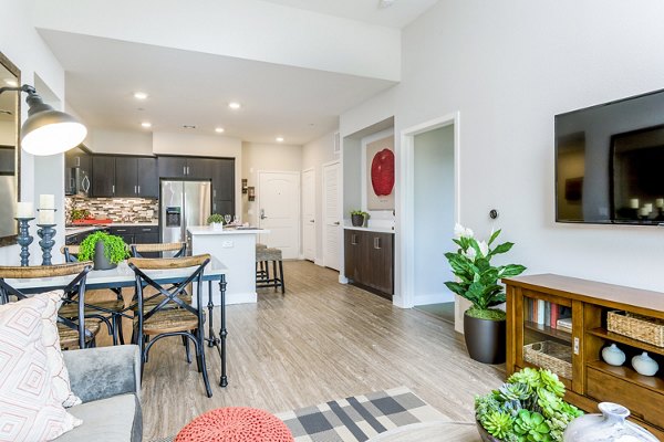 Living room with modern decor and large windows at Altura Apartments, luxury rentals in central location