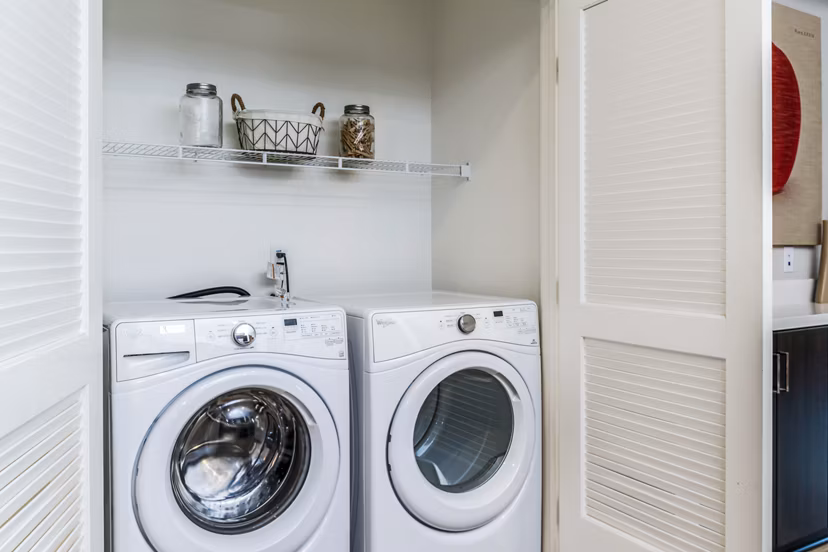 Laundry room featuring modern appliances at Altura Apartments in luxury Greystar community