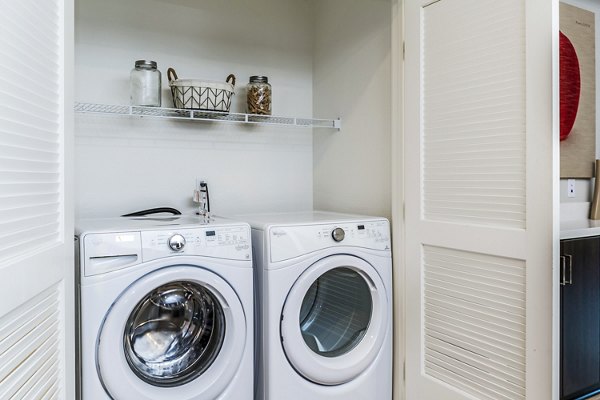 Laundry room featuring modern appliances at Altura Apartments in luxury Greystar community