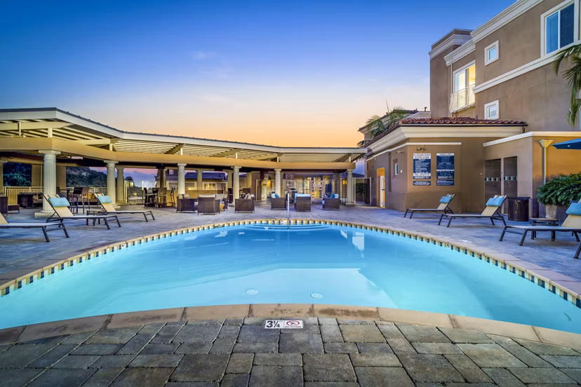 Scenic pool area with lounge chairs at Altura Apartments luxury community