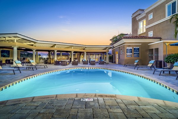 Scenic pool area with lounge chairs at Altura Apartments luxury community