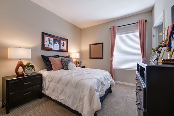 Modern bedroom featuring elegant design and ample natural light at Avino Apartments, a luxury community by Greystar