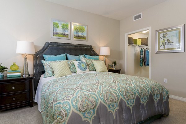 Cozy bedroom with stylish bed and modern decor in Avino Apartments