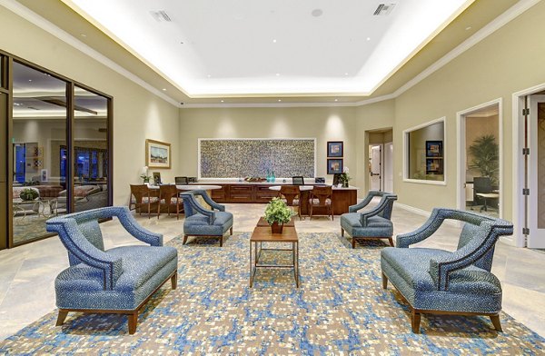Clubhouse featuring modern furnishings and large windows at Avino Apartments in San Diego