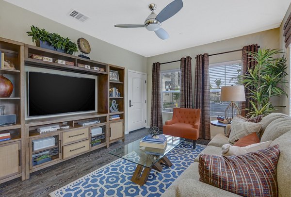 Spacious living room with modern decor and ample natural light at Avino Apartments