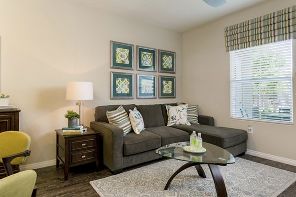 Modern living room with stylish furnishings and abundant natural light at Avino Apartments