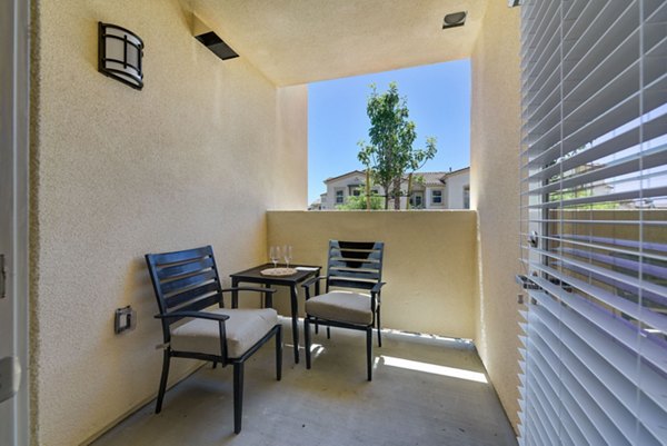Cozy patio with stylish seating at Avino Apartments, ideal for outdoor relaxation and entertainment