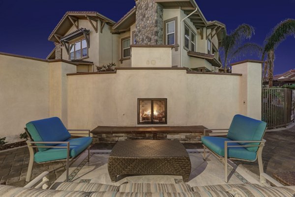 Cozy fire pit surrounded by seating at Avino Apartments, perfect for gathering in luxury outdoor space