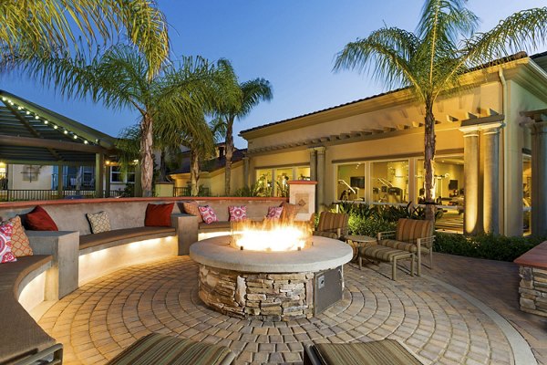 Fire pit lounge area with cozy seating at Avino Apartments