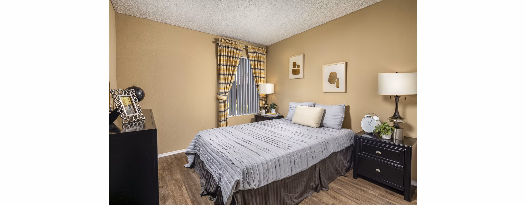 Cozy bedroom featuring sleek furniture and neutral decor in Bella Terra Apartments