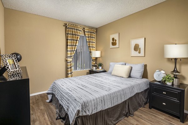Cozy bedroom featuring sleek furniture and neutral decor in Bella Terra Apartments