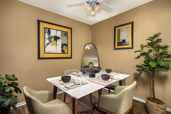 Bella Terra Apartments: Elegant dining area featuring modern furnishings and large windows