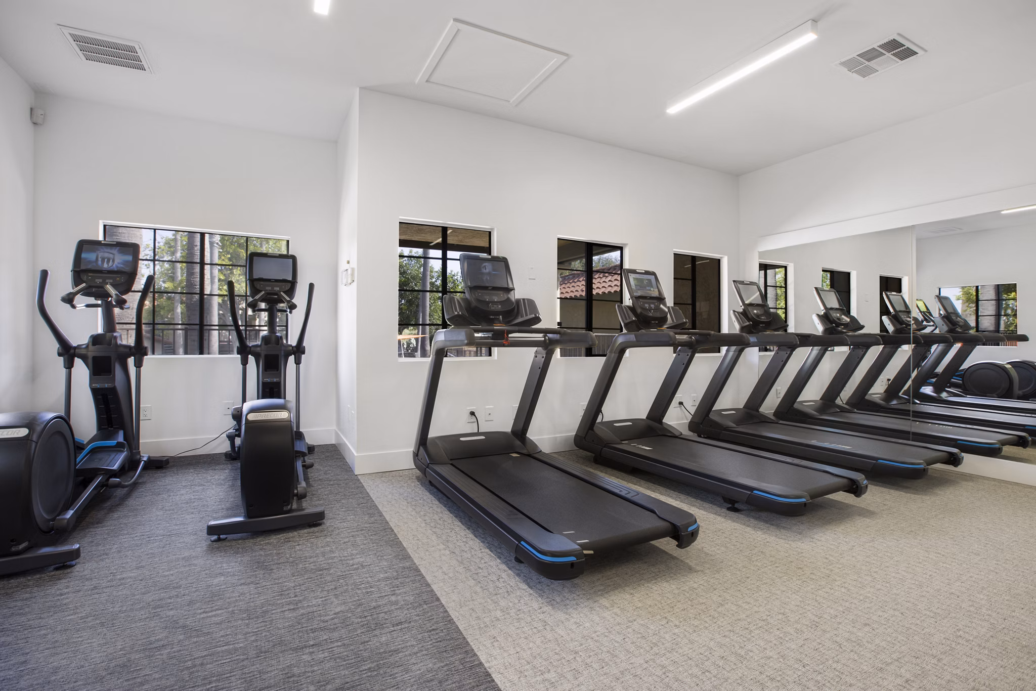 Fully-equipped fitness center with modern machines at Bella Terra Apartments