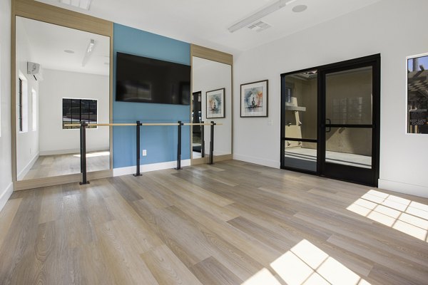 Bright yoga/spin studio with mirrored walls at Bella Terra Apartments, ideal for fitness enthusiasts seeking luxury living spaces