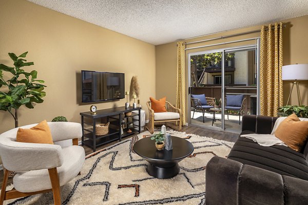 Elegant living room with modern decor and plush seating at Bella Terra Apartments