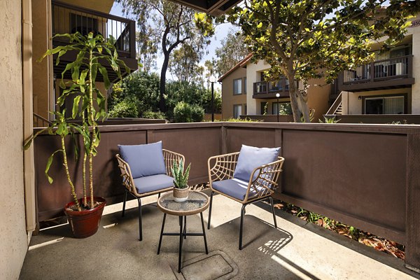 Patio with modern seating and lush greenery at Bella Terra Apartments, a luxury community offering upscale amenities and stylish living spaces
