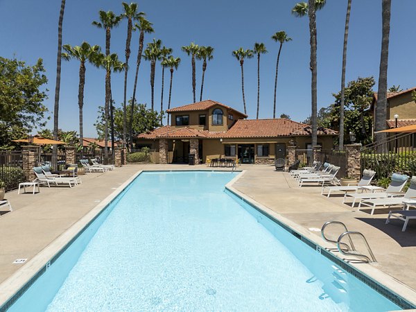 Resort-style pool with loungers at Bella Terra Apartments offering luxury living