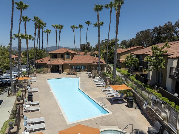 Outdoor pool area with lounge seating at Bella Terra Apartments, offering a luxurious amenity for relaxation and leisure