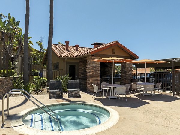 Serene outdoor pool with lounge chairs at Bella Terra Apartments, offering a luxurious relaxation experience