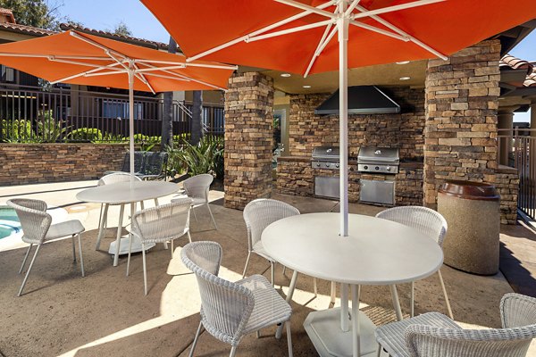 Bella Terra Apartments: Lush courtyard with landscaped gardens, seating areas, and walking paths for relaxation