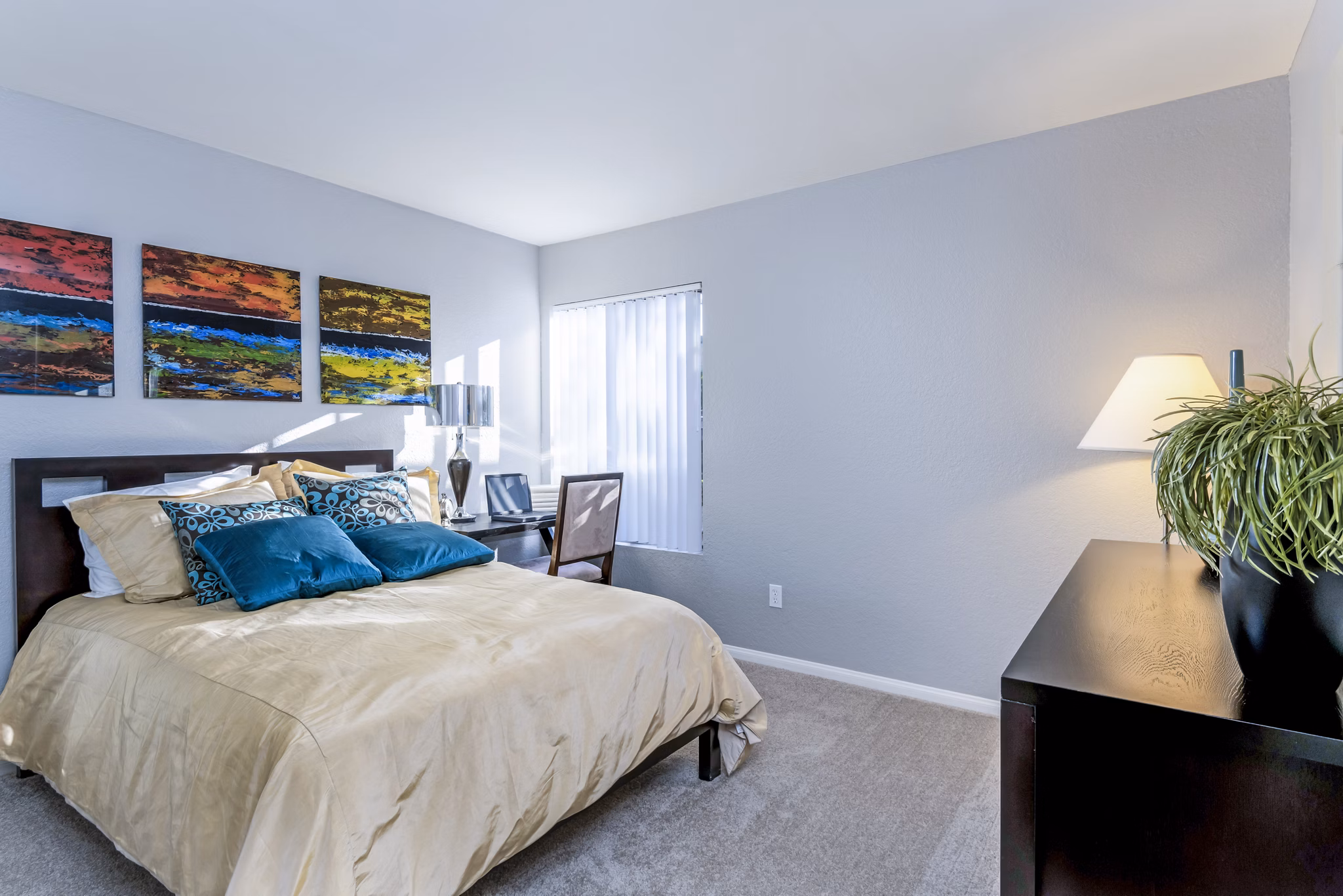 Cozy bedroom featuring elegant decor and natural light at The Casas Apartments, luxury living by Greystar