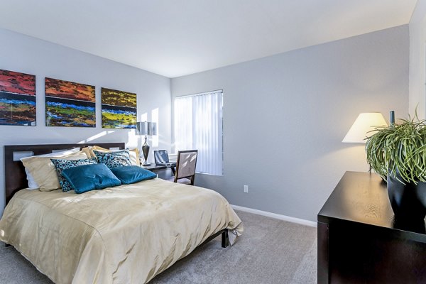 Cozy bedroom featuring elegant decor and natural light at The Casas Apartments, luxury living by Greystar