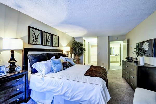 Cozy bedroom with modern decor in The Casas Apartments, showcasing luxury living in an inviting space