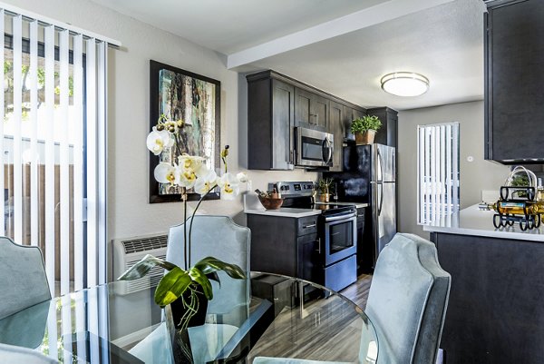 Dining room with modern lighting and elegant seating in The Casas Apartments