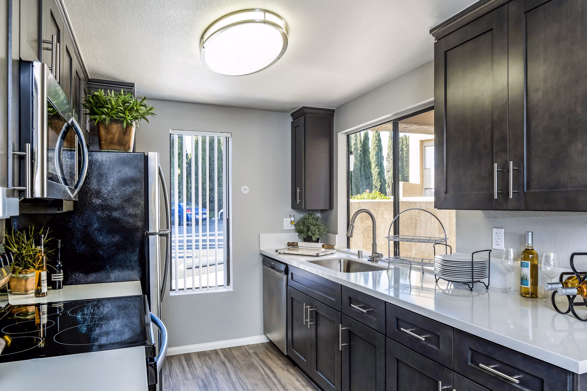 Modern kitchen with stainless steel appliances and island at The Casas Apartments