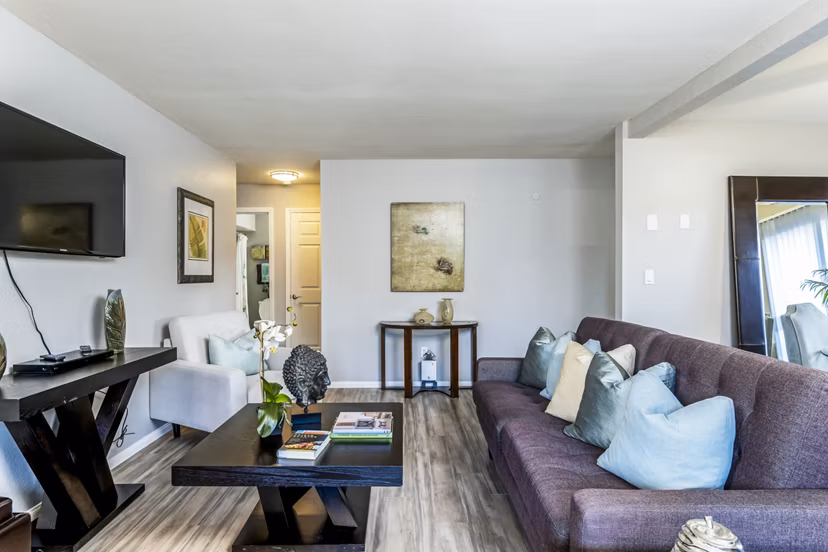 Spacious living room with natural lighting and modern decor at The Casas Apartments in Greystar luxury community