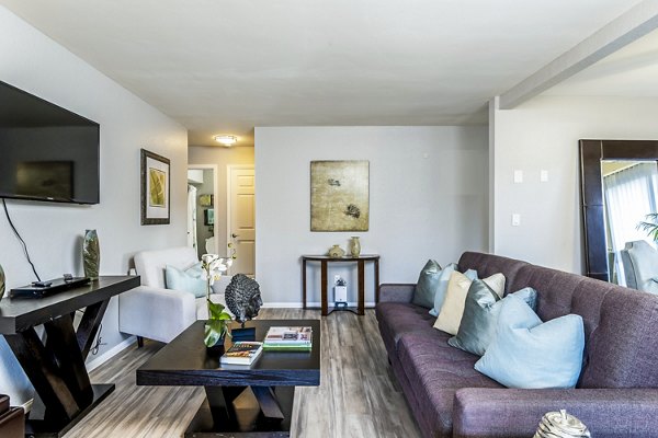Spacious living room with natural lighting and modern decor at The Casas Apartments in Greystar luxury community