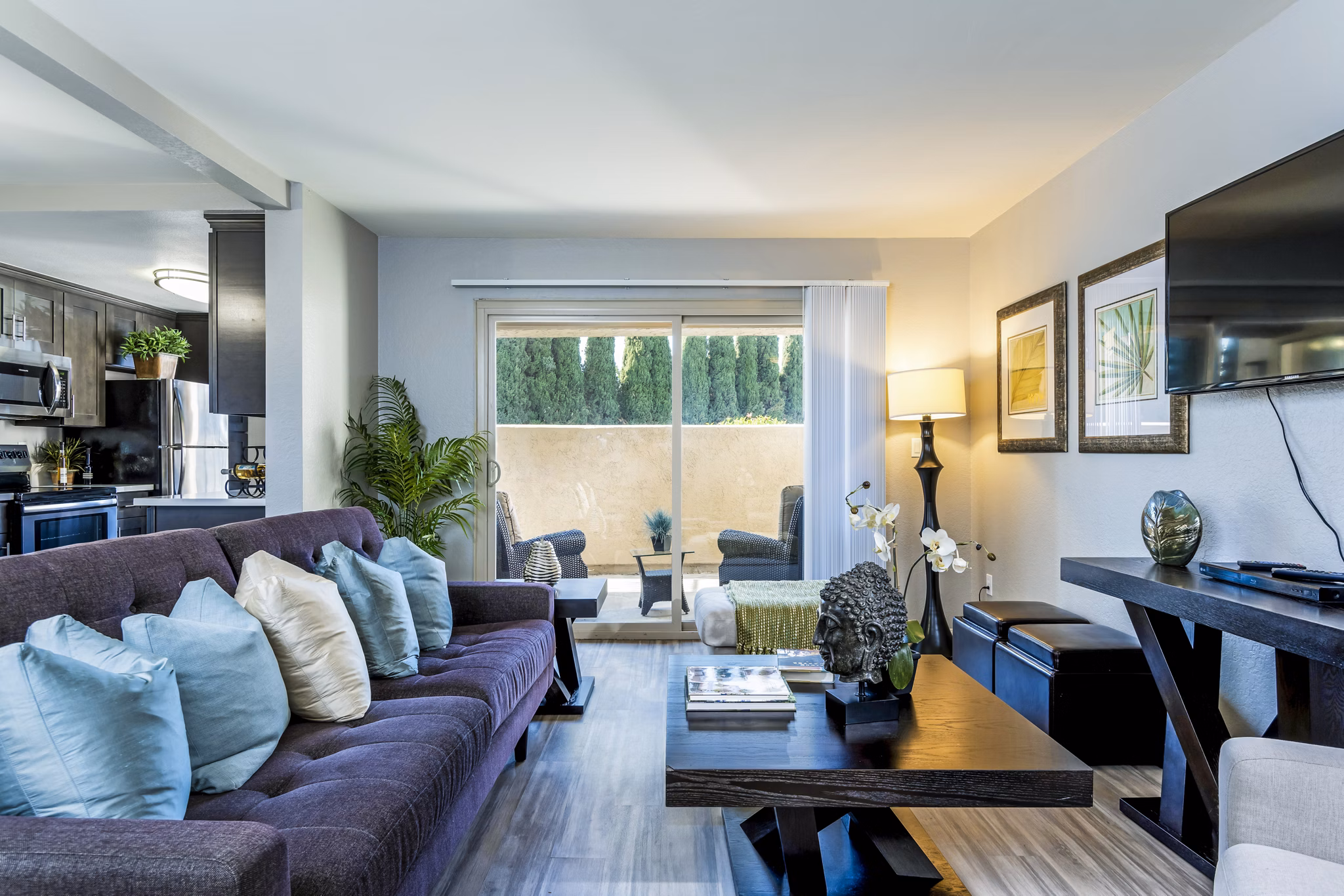 Modern living room with plush seating and natural light at The Casas Apartments in a luxury Greystar community
