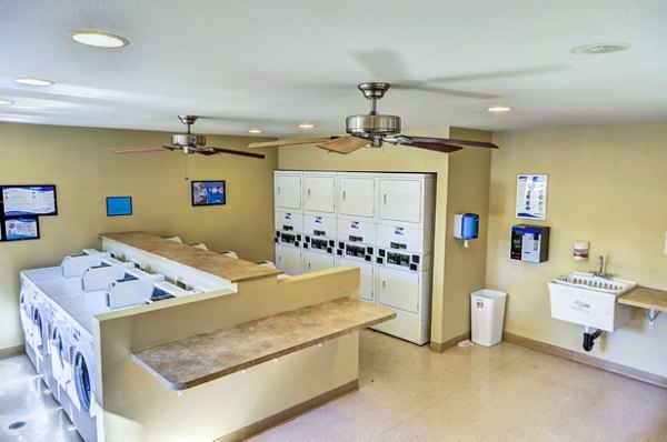 Laundry room with washers and dryers at The Casas Apartments
