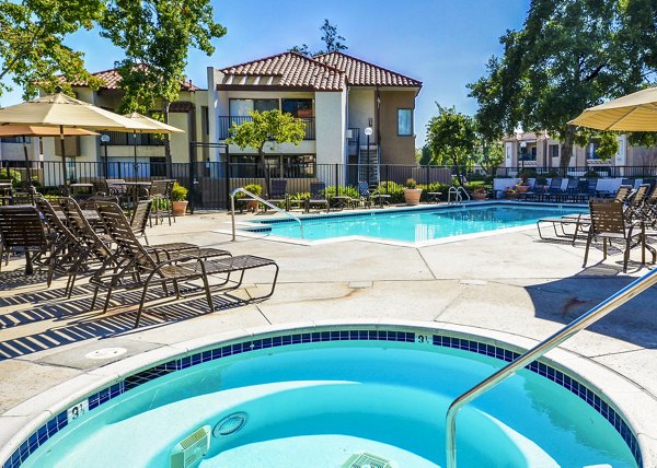 Relaxing poolside with hot tub at The Casas Apartments, a luxury community by Greystar
