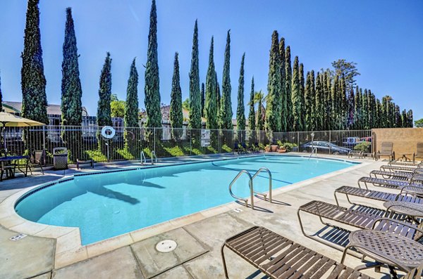 Olympic-size pool at The Casas Apartments with luxury seating areas in a Greystar community