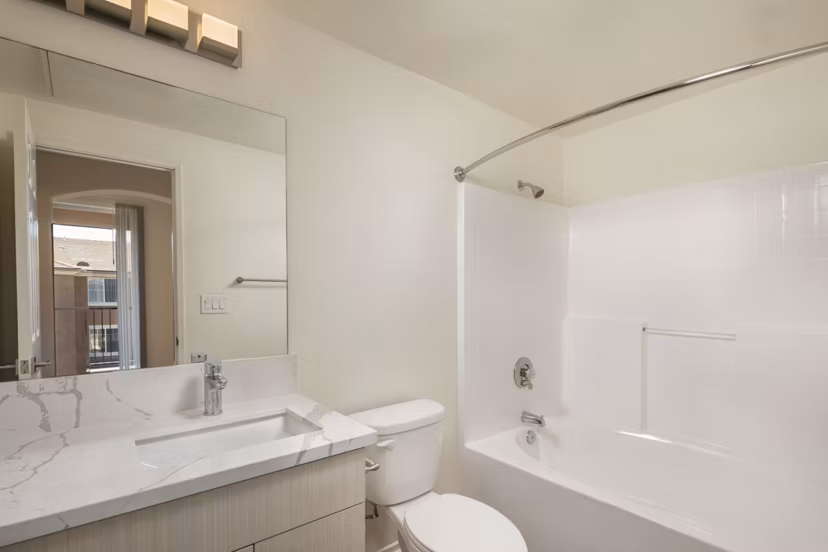 Modern bathroom with sleek fixtures at Casoleil Apartments featuring luxury finishes and contemporary design
