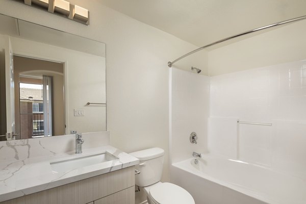 Modern bathroom with sleek fixtures at Casoleil Apartments featuring luxury finishes and contemporary design