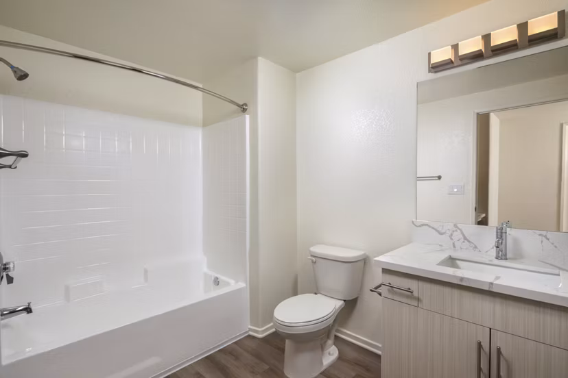 Bathroom featuring modern fixtures and sleek countertops at Casoleil Apartments