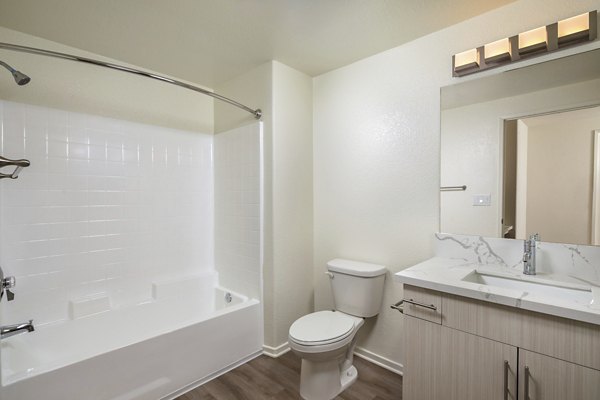 Bathroom featuring modern fixtures and sleek countertops at Casoleil Apartments