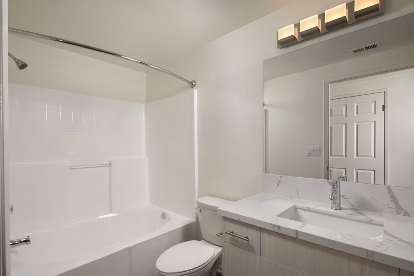 Modern bathroom with sleek fixtures and marble countertops at Casoleil Apartments, a luxury Greystar community