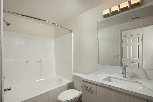 Modern bathroom with sleek fixtures and marble countertops at Casoleil Apartments, a luxury Greystar community