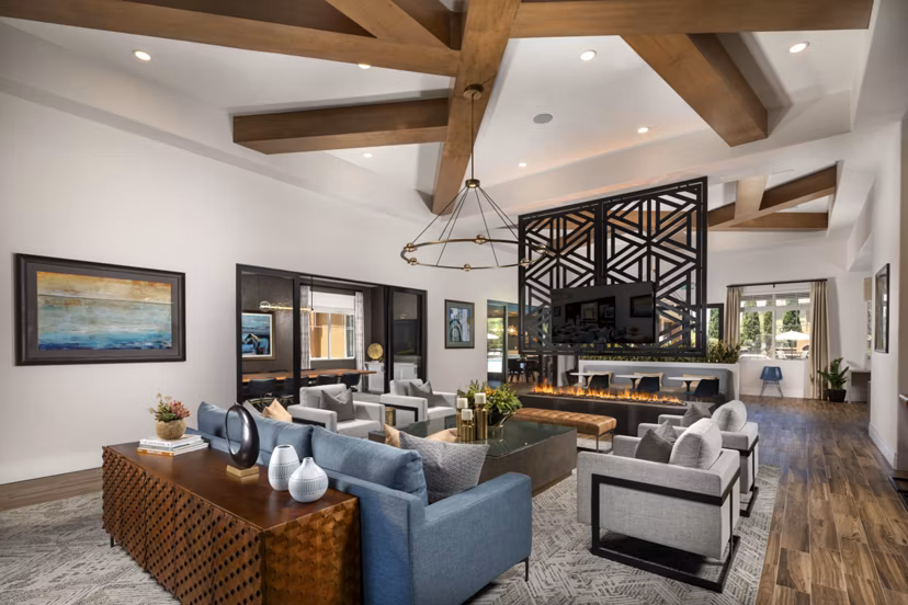 Modern clubhouse with lounge seating and large windows at Casoleil Apartments in sunny California