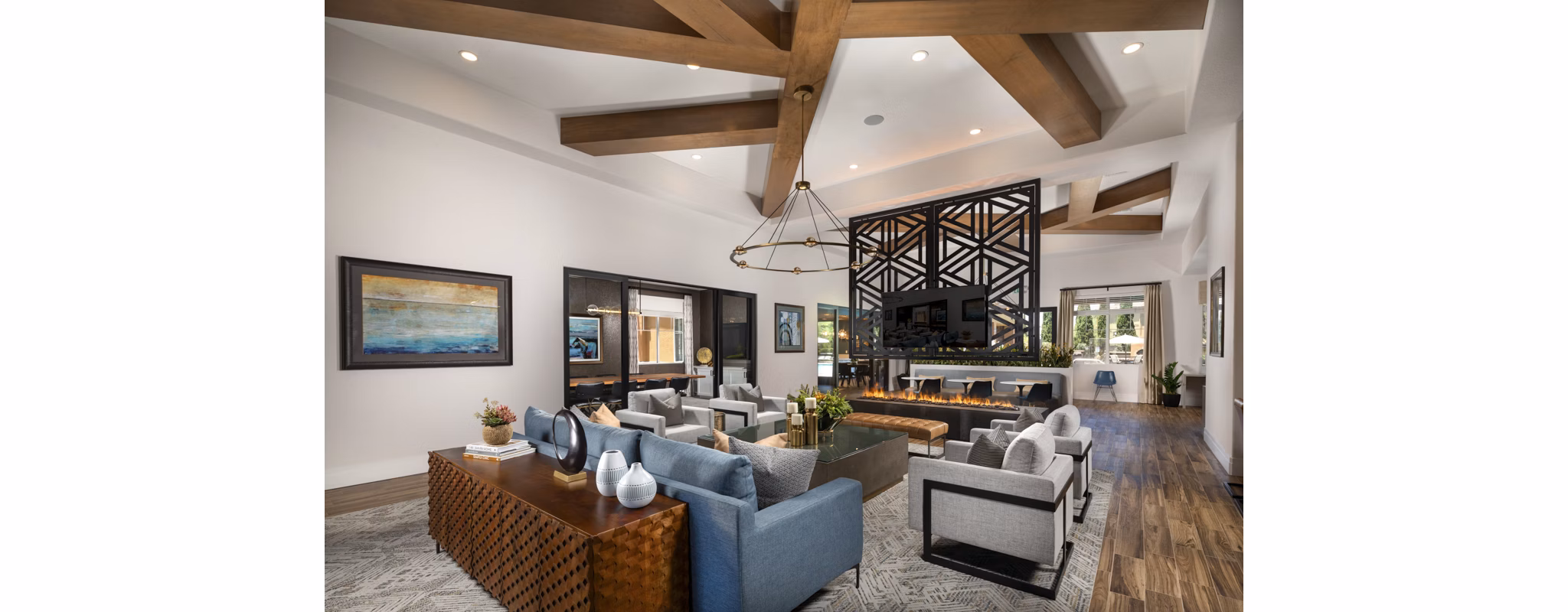 Modern clubhouse with lounge seating and large windows at Casoleil Apartments in sunny California